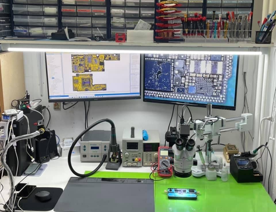 AppleXtreme's certified repair bench with diagnostic equipment